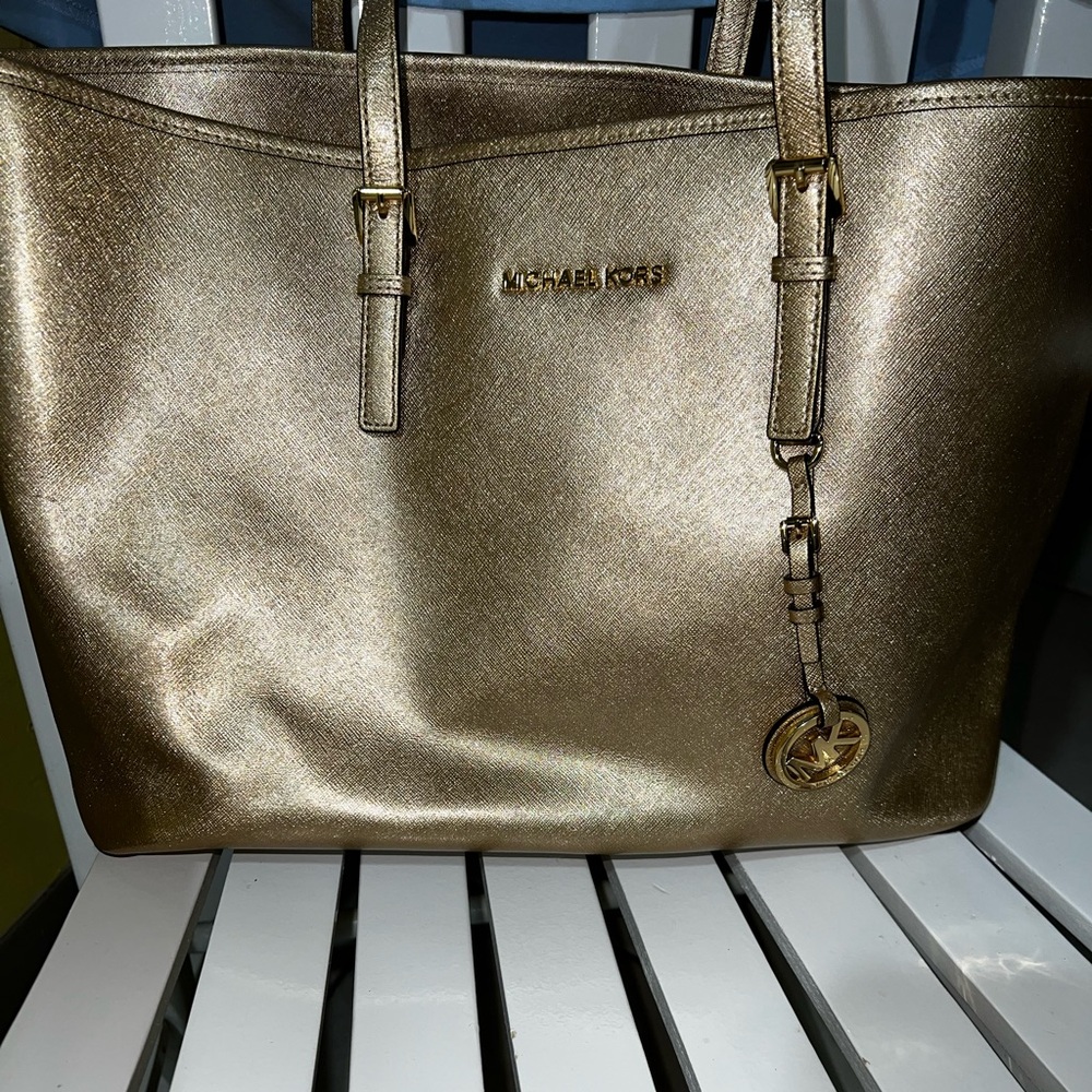 Mildly used, gold Michael Kors pocketbook.